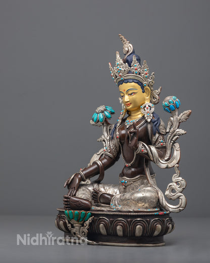 Detailed close-up of Green Tara’s serene face with gold gilding and intricate hand-carved craftsmanship.