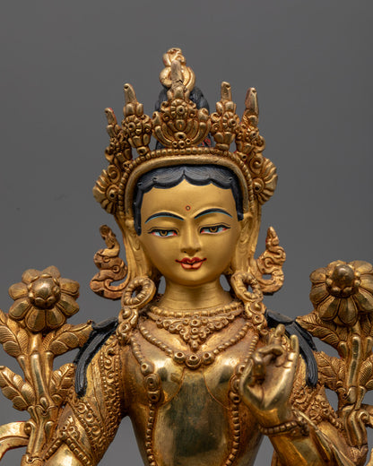Green Tara statue holding a blue lotus, showcasing vibrant acrylic colors and intricate craftsmanship.