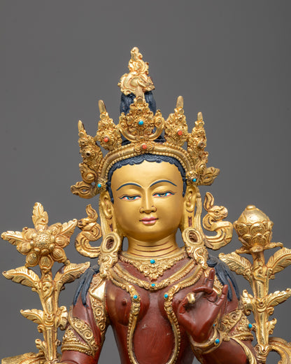 Detailed close-up of Green Tara statue’s radiant 24k gold gilded face