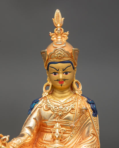 Detailed close-up of Guru Rinpoche face with gold paint and serene expression