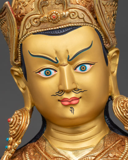 Detailed close-up of Guru Rinpoche face, wrathful yet compassionate, gold finish