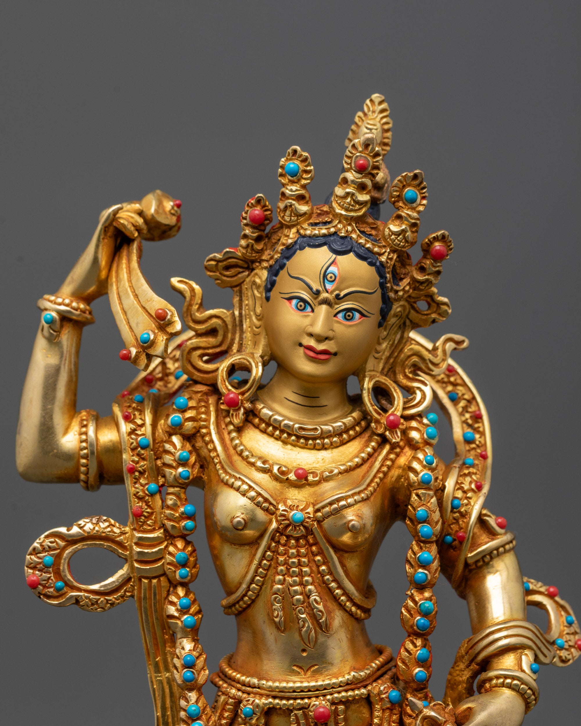Detailed close-up of Machig Labdron holding damaru hand drum and vajra-handled