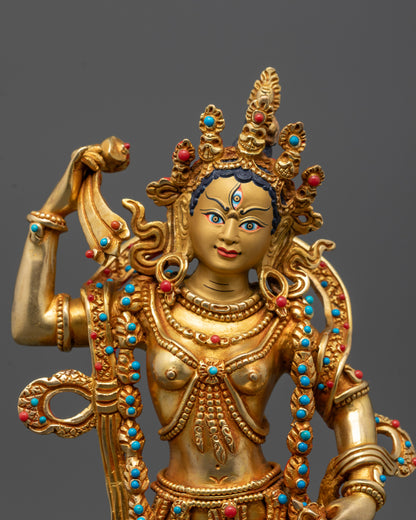 Detailed close-up of Machig Labdron holding damaru hand drum and vajra-handled