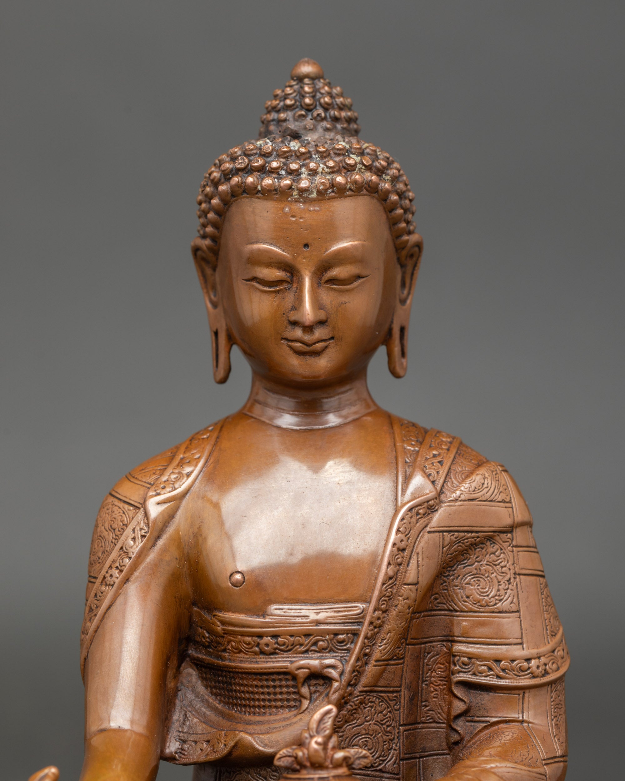 Detailed close-up of Medicine Buddha face with serene expression and traditional Nepalese oxidized finish for meditation and devotional practice