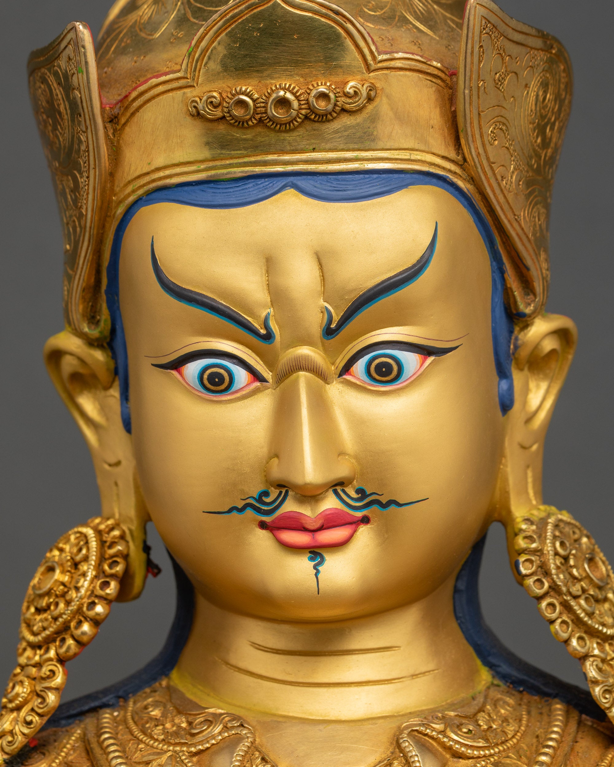 Detailed close-up of Padmasambhava Statue face, Gold-painted features, Nepalese craftsmanship