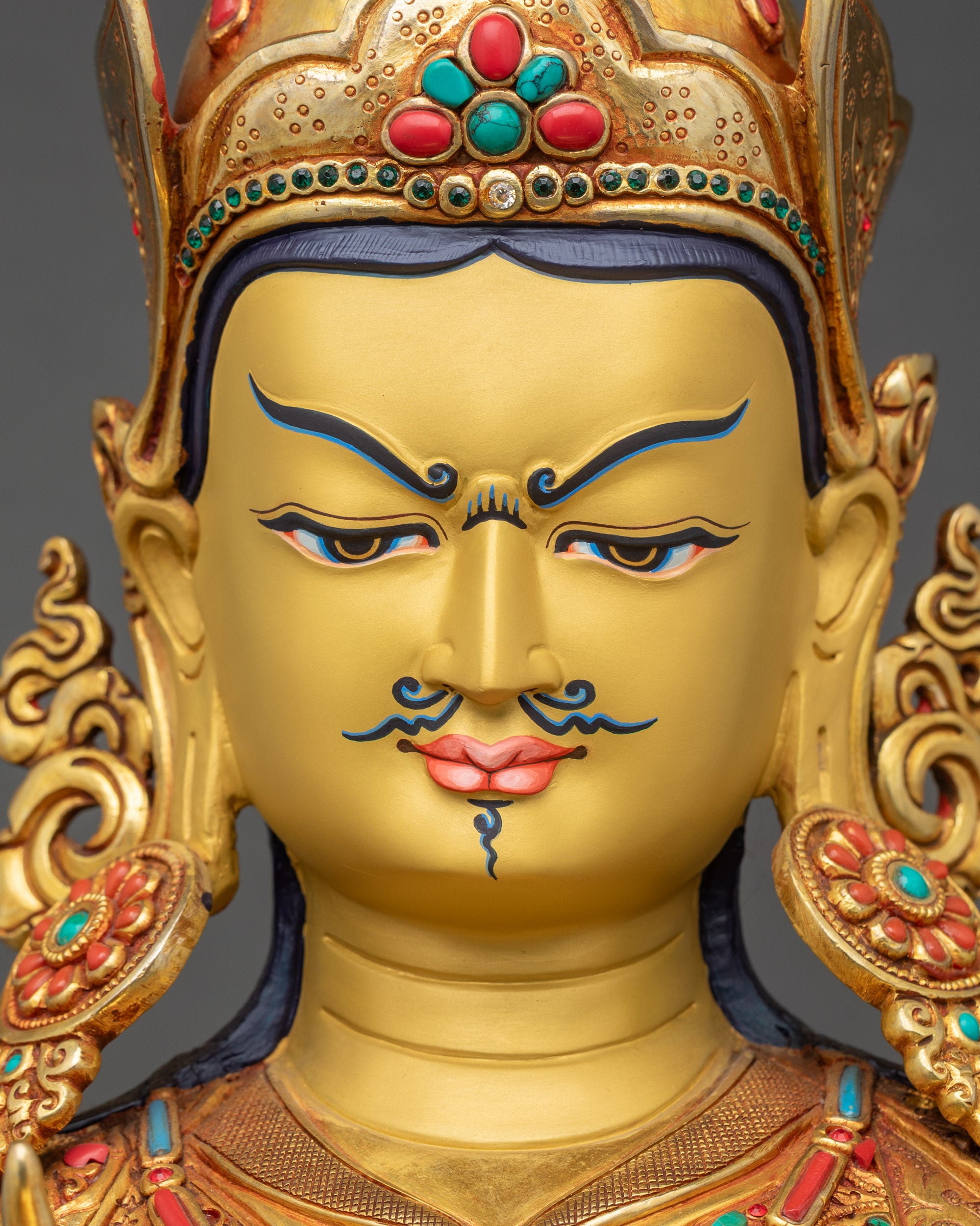 Detailed close-up of Tsokye Dorje Statue face with serene expression and gold-painted features