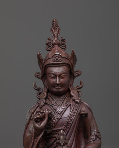 Detailed close-up of Tsokye Dorje gold-painted face and five-petaled lotus hat, Nepalese devotional Buddhist artwork