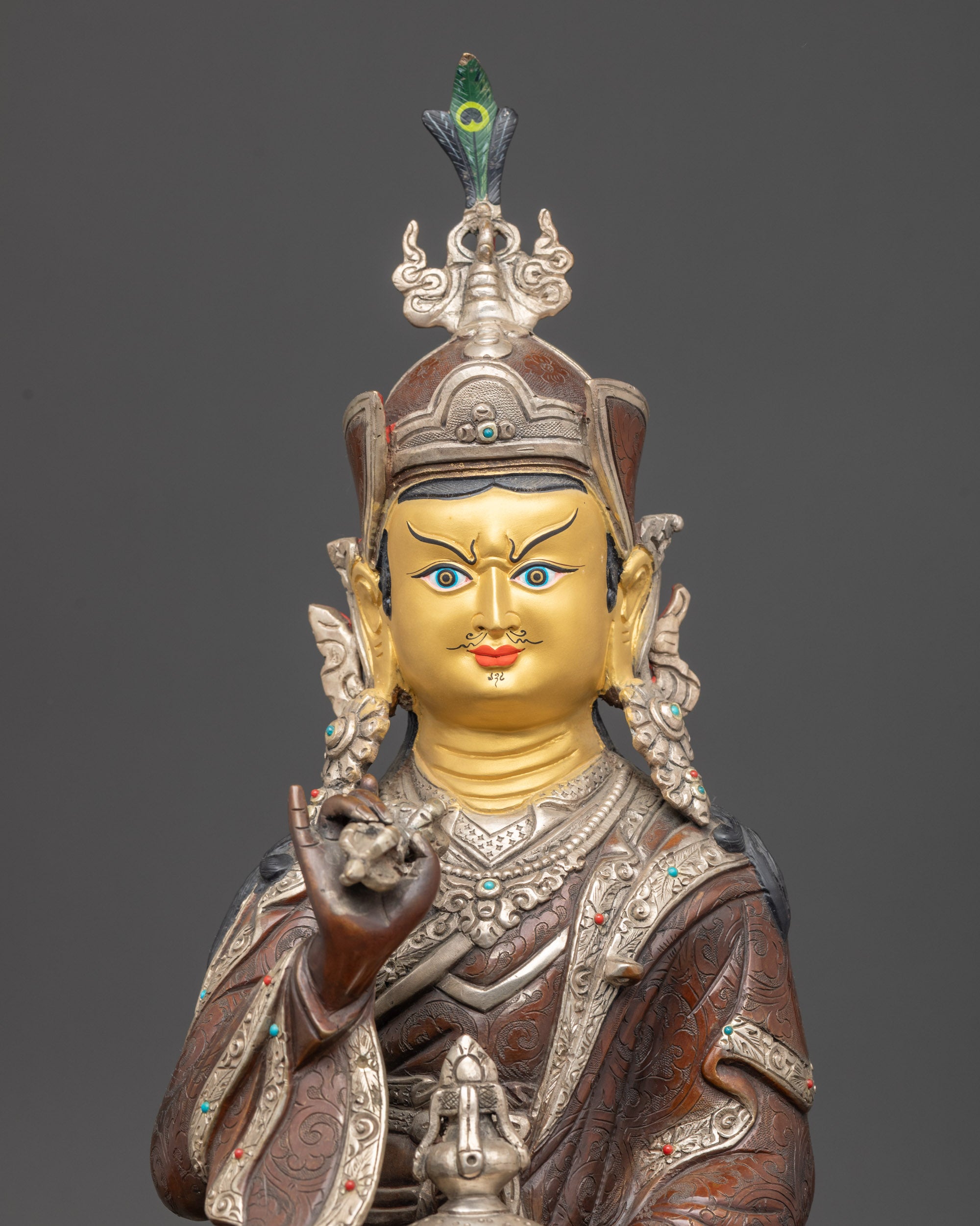 Detailed close-up of Tsokye Dorje statue face with 24K gold, oxidized and silver-plated finish