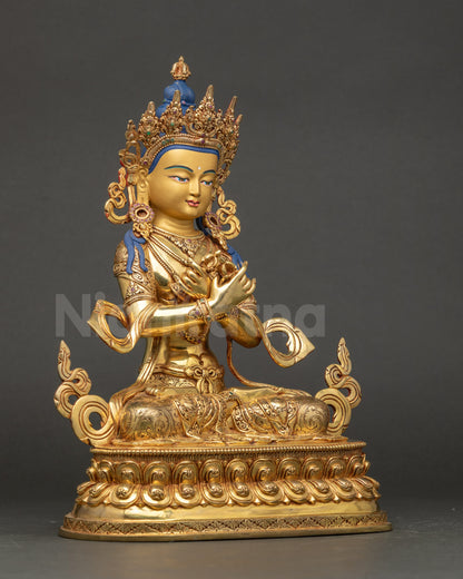 Detailed close-up of Vajradhara Statue serene gold face with five-jeweled crown