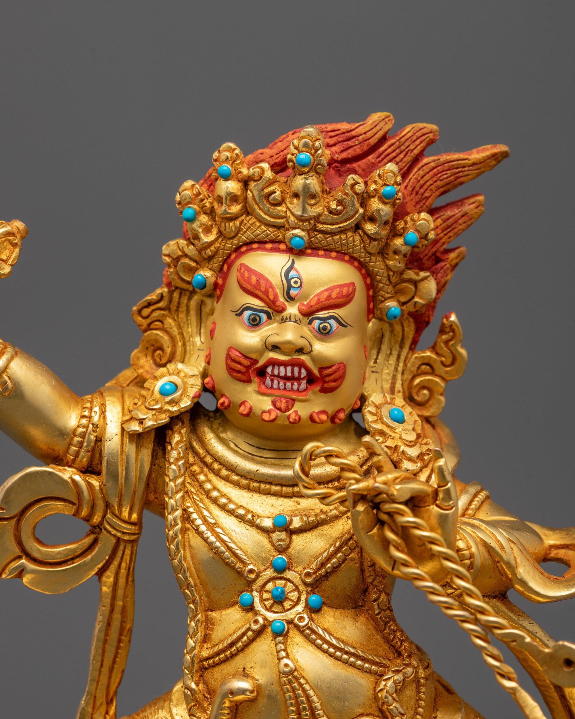 Detailed close-up of Vajrapani Statue’s 24k gold gilded face and fierce halo