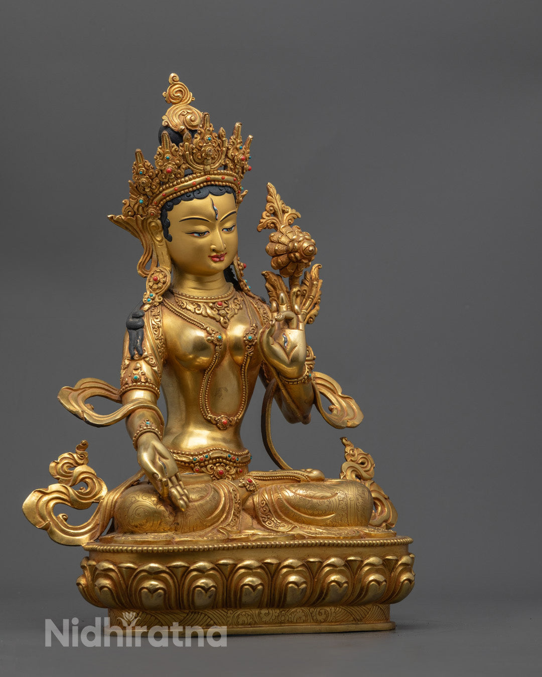 White Tara statue’s serene face, gold-gilded and hand-painted with multi-layer acrylics, symbolizing compassion and healing.