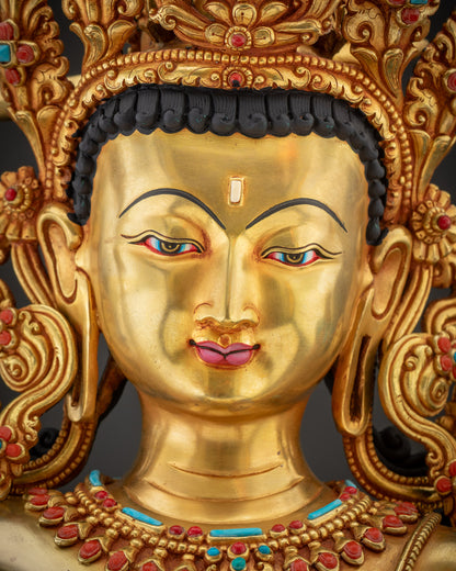 Detailed close up Maha Manjushri Statue serene fire gold gilded face handcrafted by Nepalese artisans
