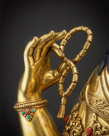 Detailed close up crystal rosary held by Avalokiteshvara spiritual sculpture
