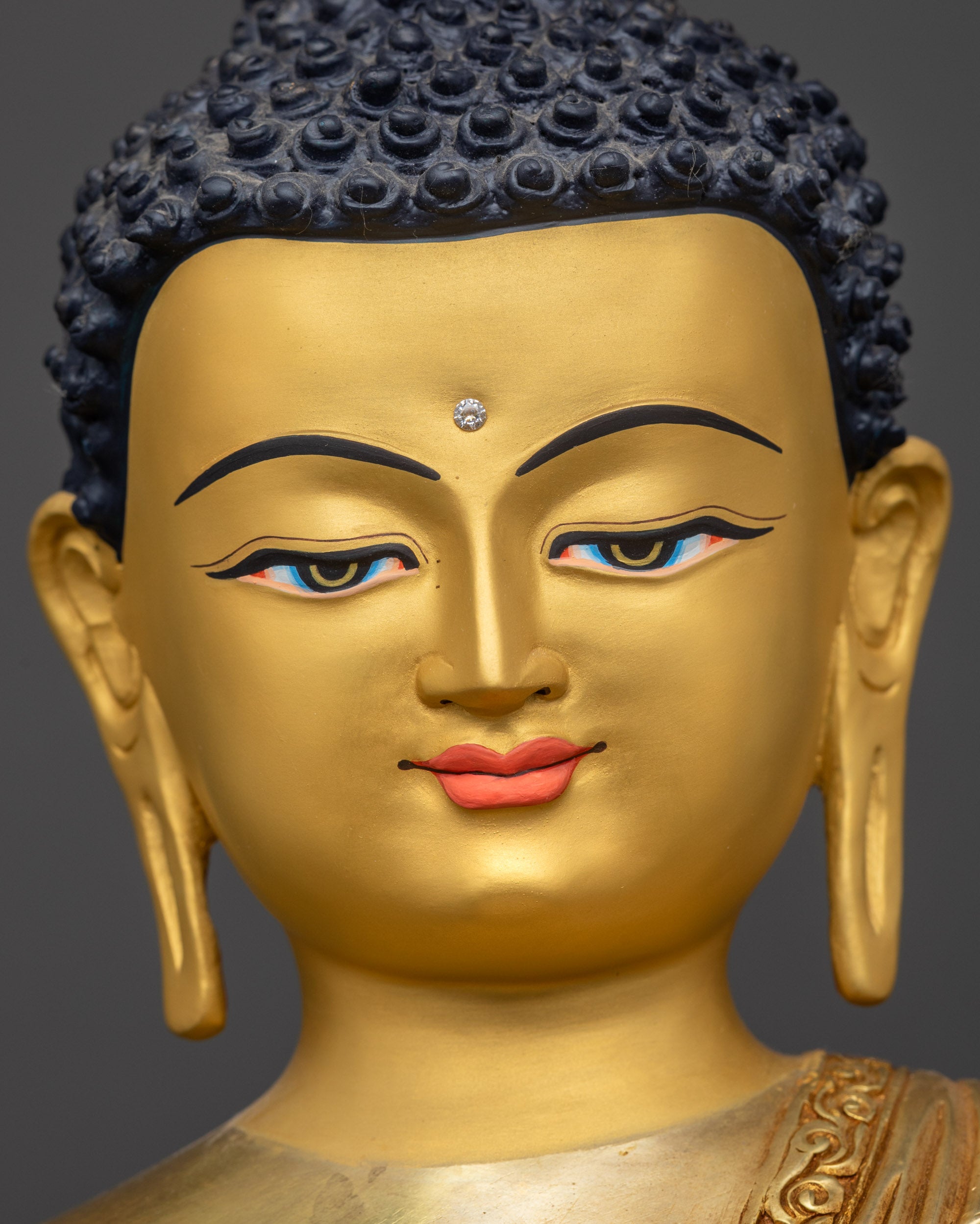 Detailed close up face Amitabha Buddha with luminous 24K gold-gilded face
