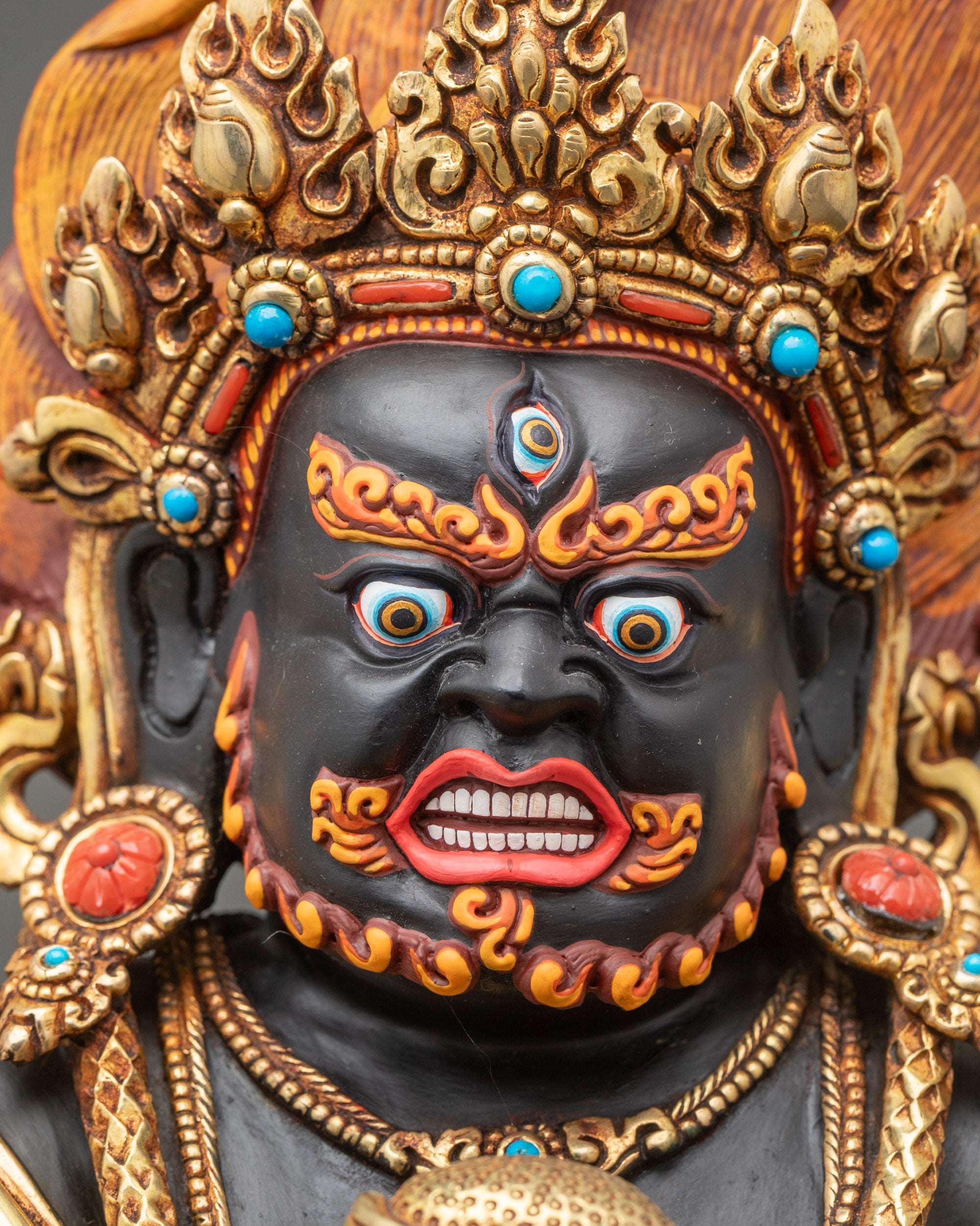 Detailed close up face – Black Dzambhala wrathful face with bared fangs and wide-set eyes, Nepalese copper
