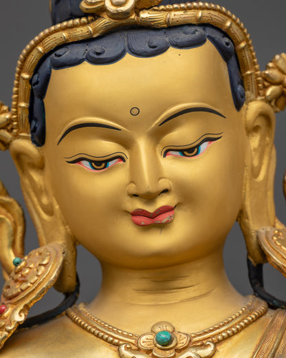 Detailed close up face Green Tara Statue showing serene expression and Utpala flower
