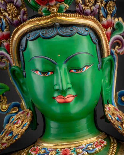 Detailed close up face Green Tara hand-painted features and gold accents