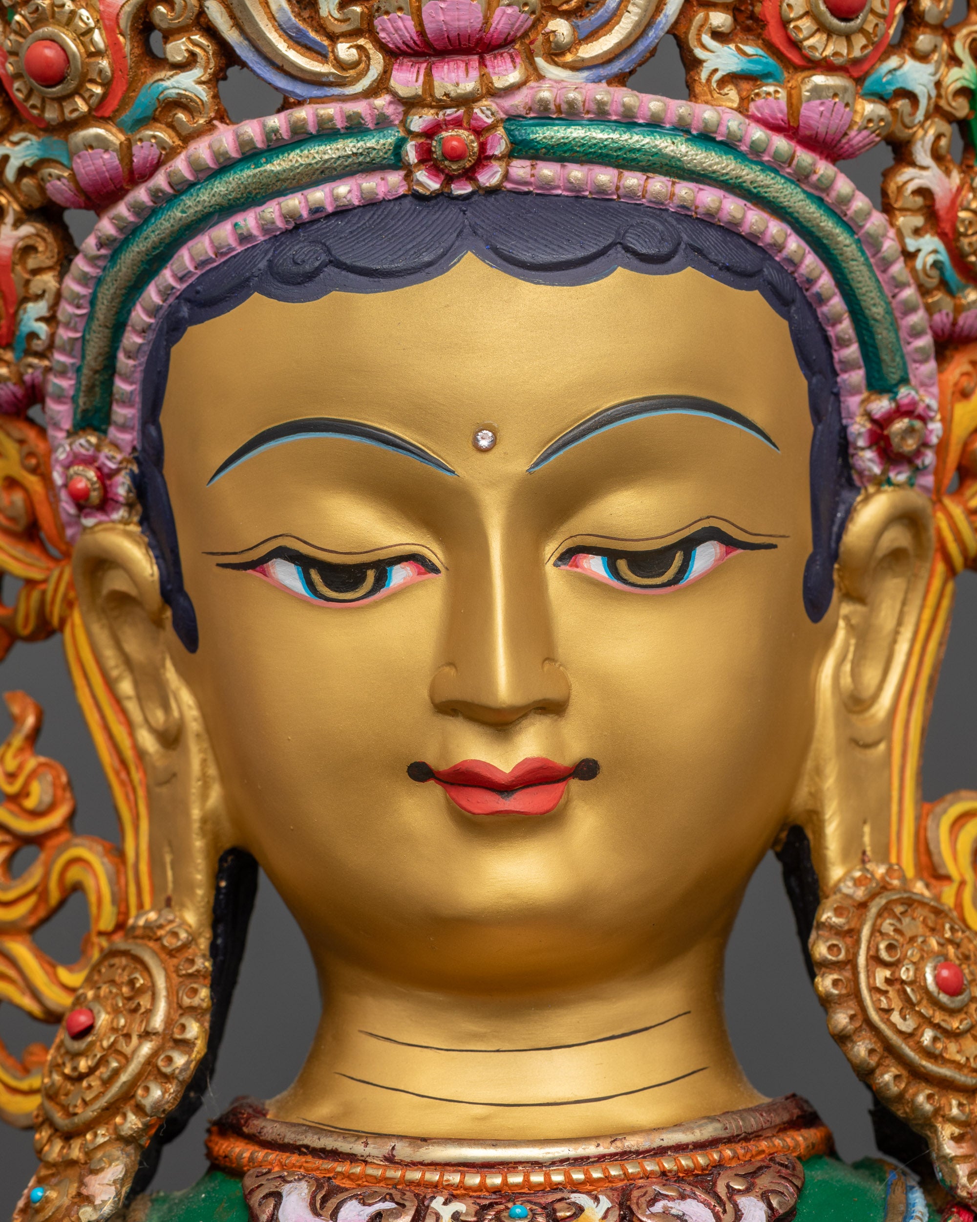 Detailed close up face Green Tara statue serene face five-jeweled crown close up
