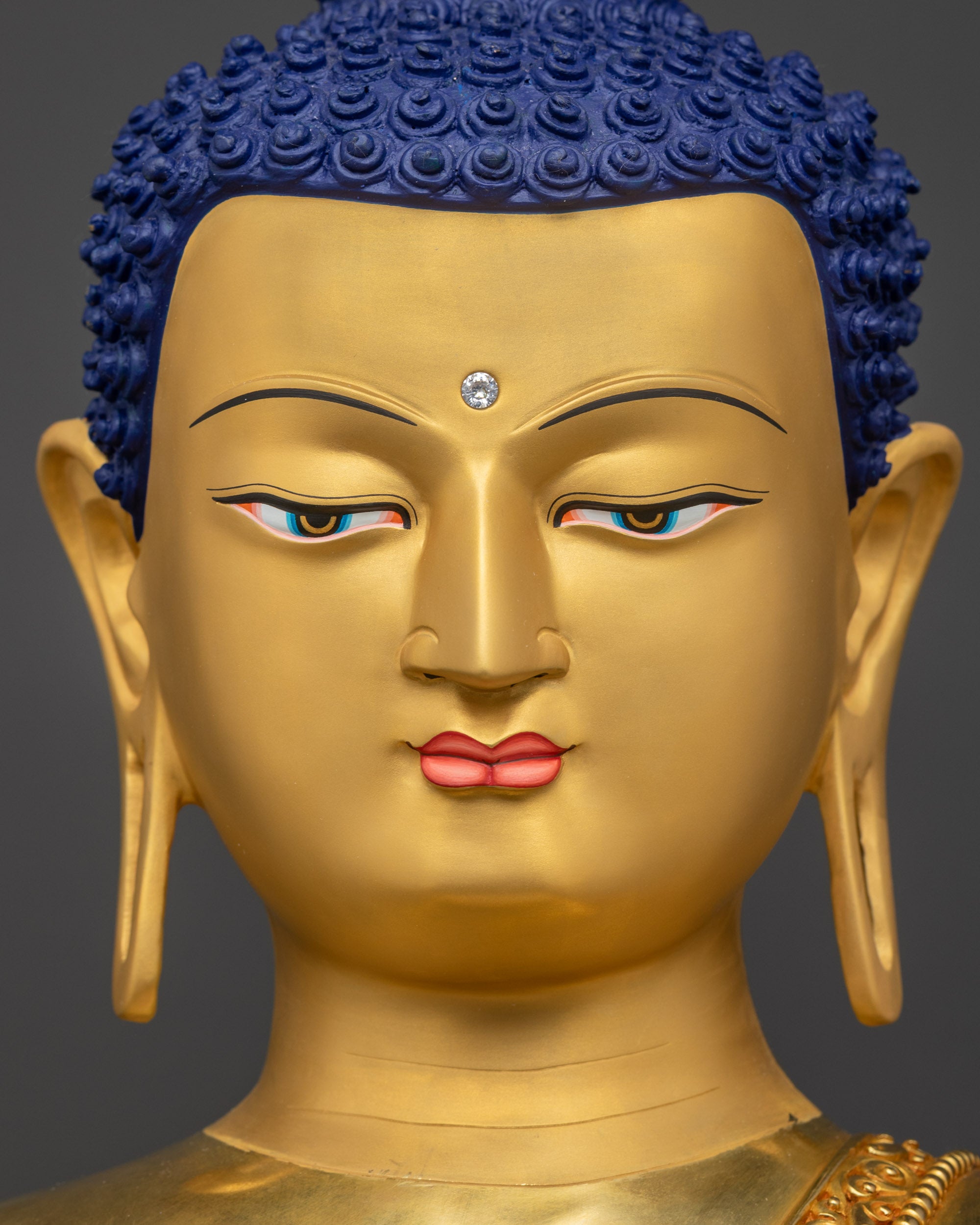 Detailed close up face Shakyamuni Buddha statue showing enlightened expression
