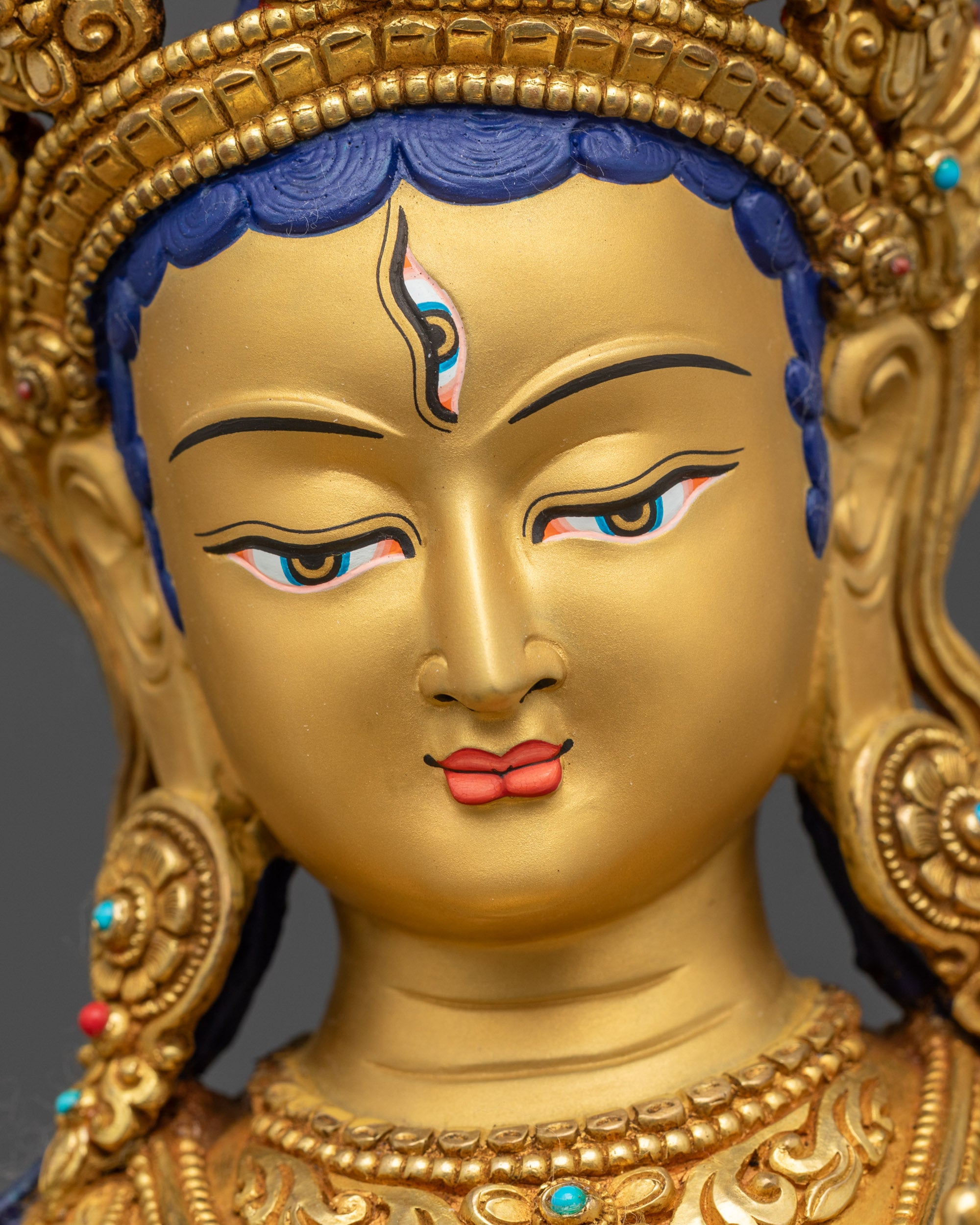 Detailed close up face White Tara serene expression gold-gilded face with seven seeing eyes

