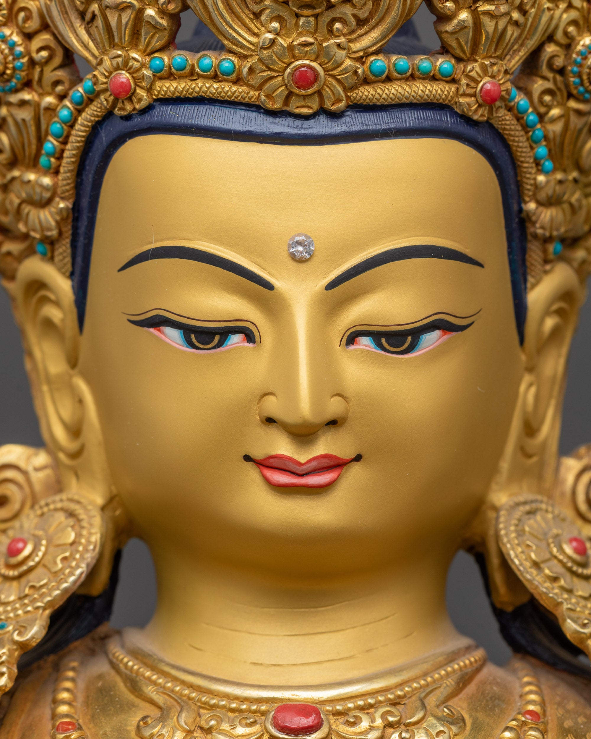 Detailed close up face of Chenrezig showing delicate jewelry and serene expression
