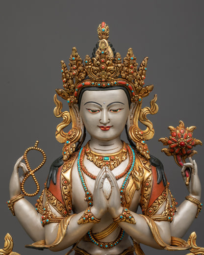 Regular close up Chenrezig statue showing four arms and symbolic treasures
