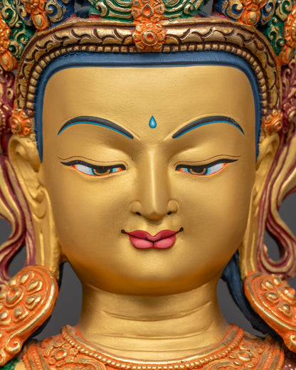 Detailed close up face of Chenrezig statue showing 24K gold-gilded features
