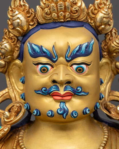 Detailed close up face of Dzambhala with wrathful expression and five-jeweled crown
