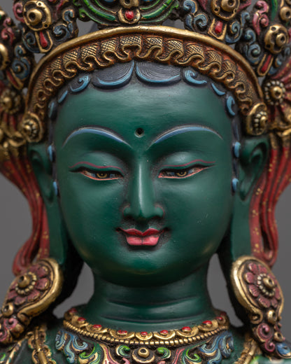 Detailed close up face of Green Tara showing five-jeweled crown and luminous gold-gilded robe
