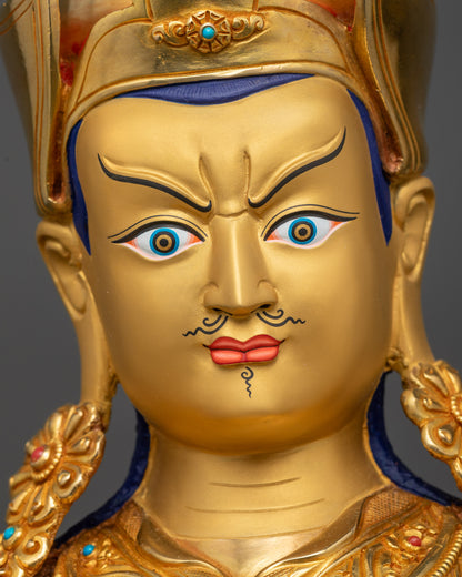 Detailed close up face of Guru Rinpoche statue with skull cup and Dorje
