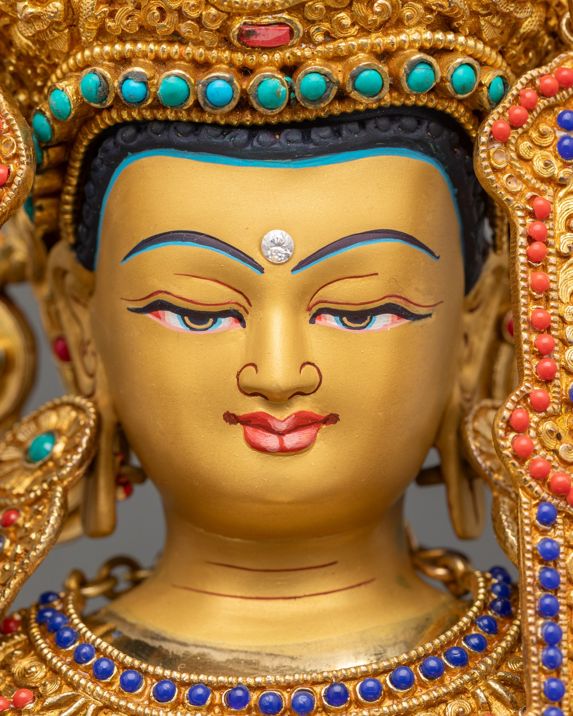 Detailed close up face of Jowo Rinpoche Statue with serene gold-gilded expression