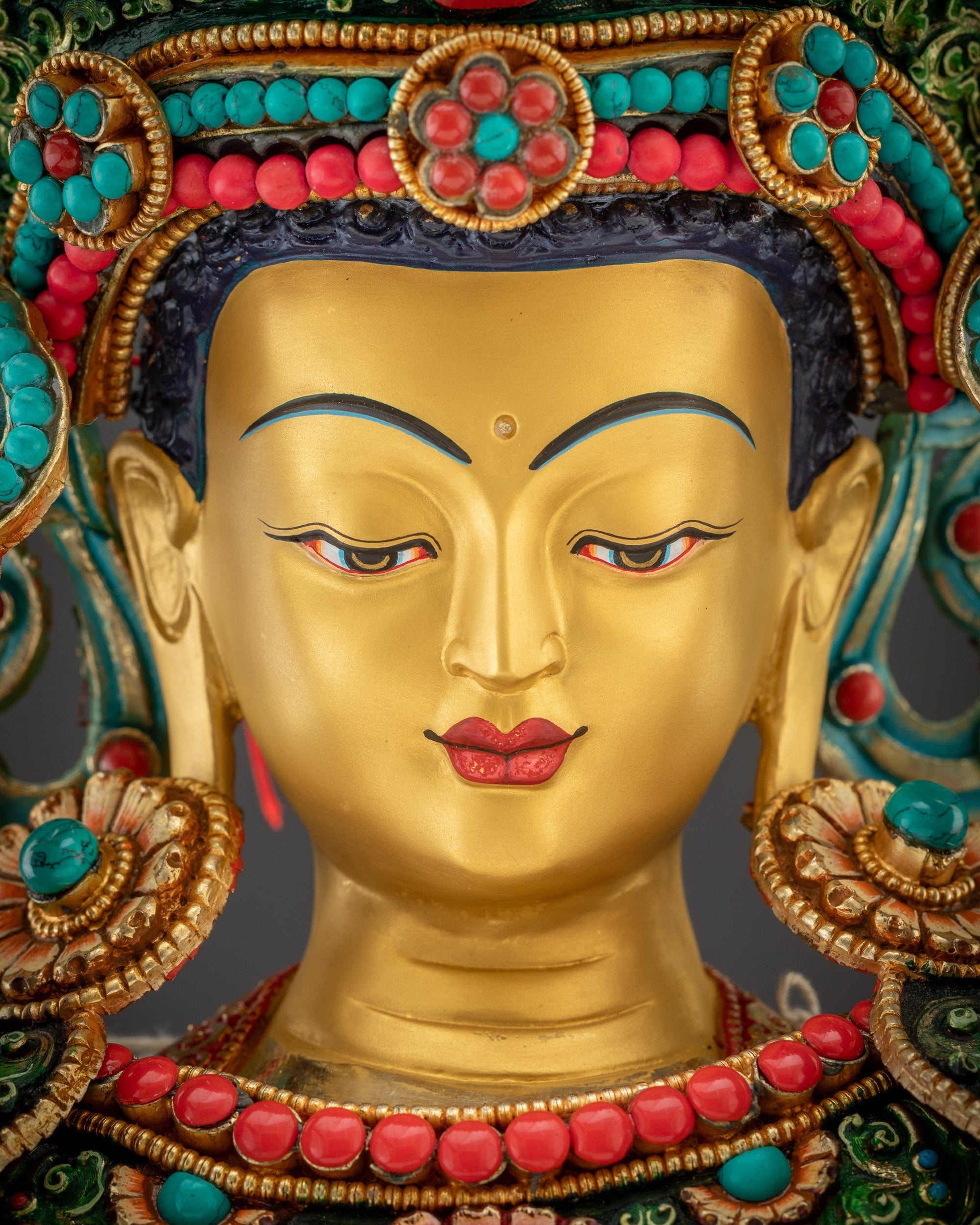 Detailed close up face of Jowo Rinpoche statue with five Buddhas and serene expression

