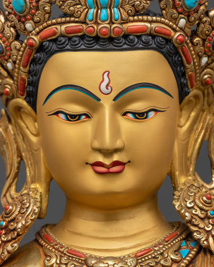 Detailed close up face of Maitreya Buddha with serene expression and gold gilding