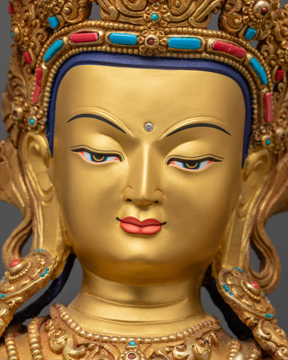 Detailed close up face of Manjushri Buddha with serene expression and gold-gilded features
