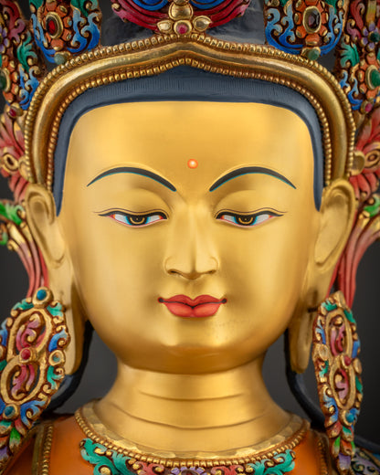 Detailed close up face of Manjushri statue showing serene expression and gold finish
