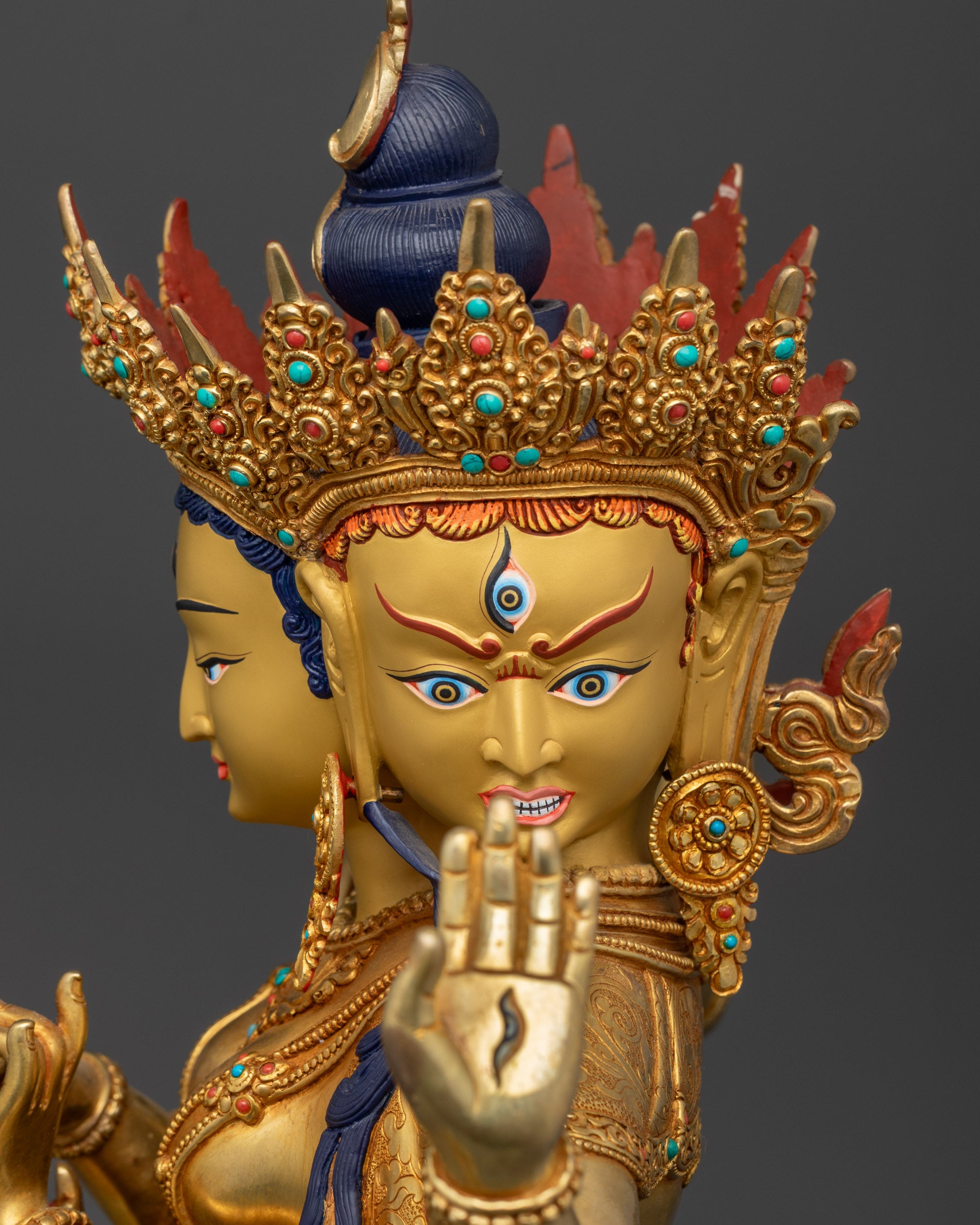 Detailed close up face of Namgyalma Ushnishavijaya statue showing wrathful expression and fierce gaze