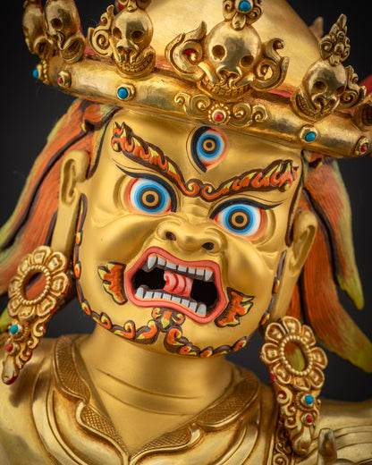 Detailed close up face of Nechung Chuyong Statue with third eye and red eyebrows