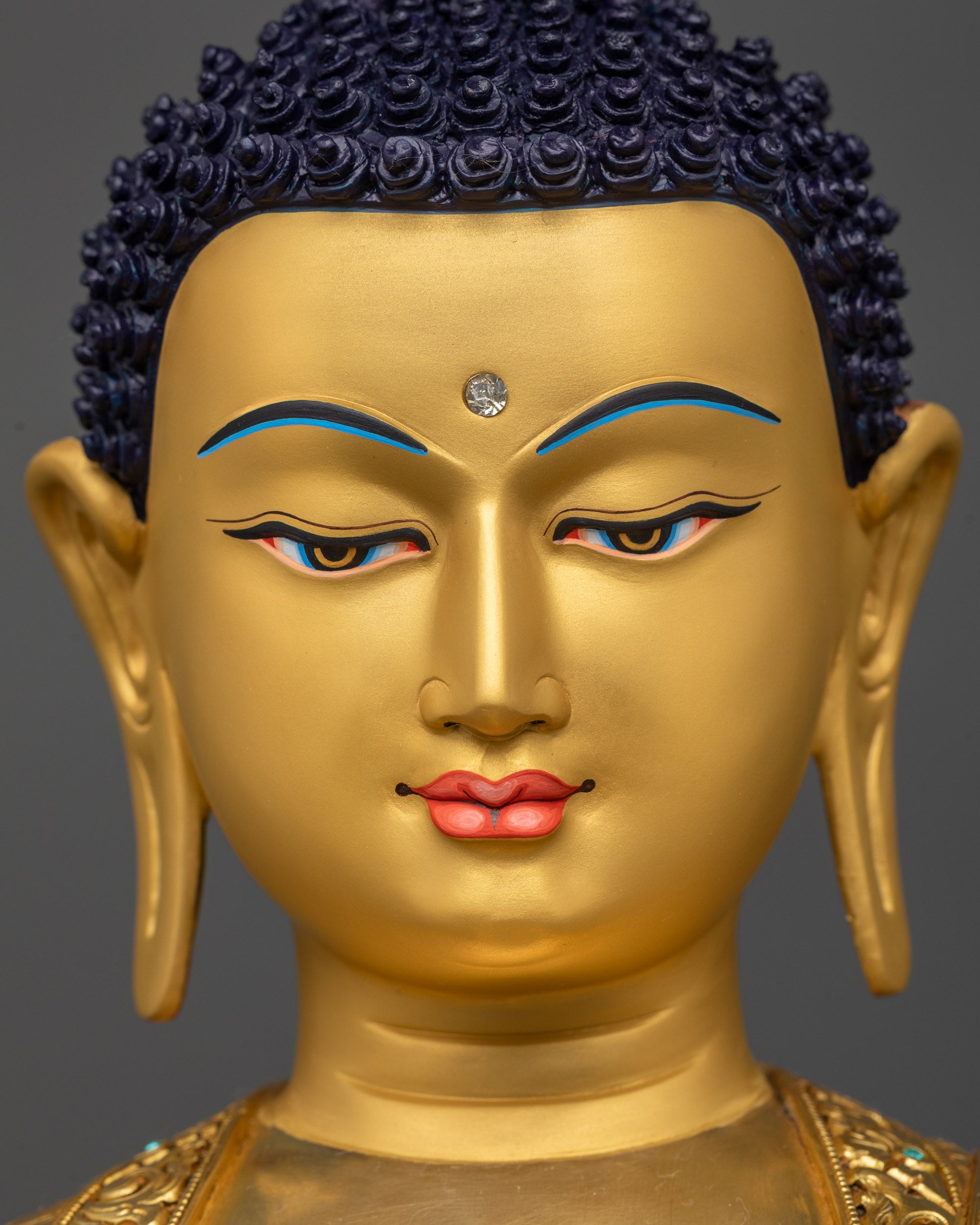 Detailed close up face of Shakyamuni Buddha Statue showing serene expression
