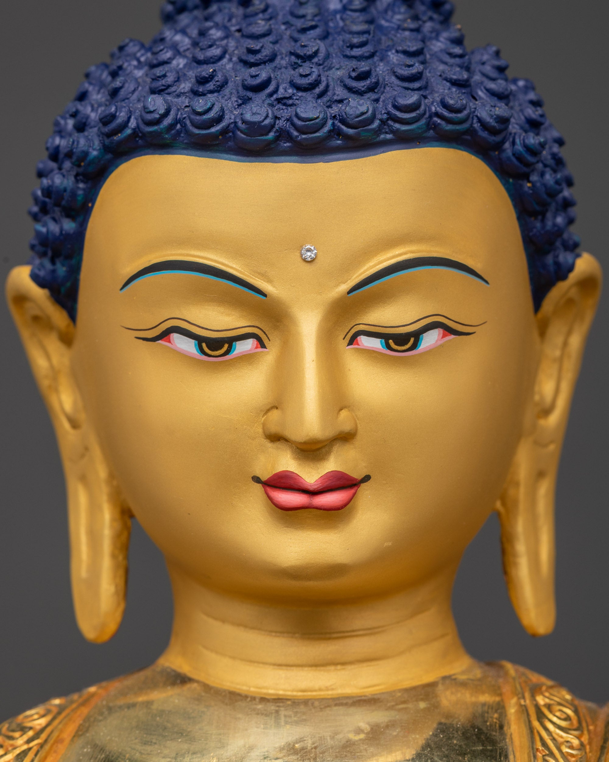 Detailed close up face of Shakyamuni Buddha with serene gold-gilded expression
