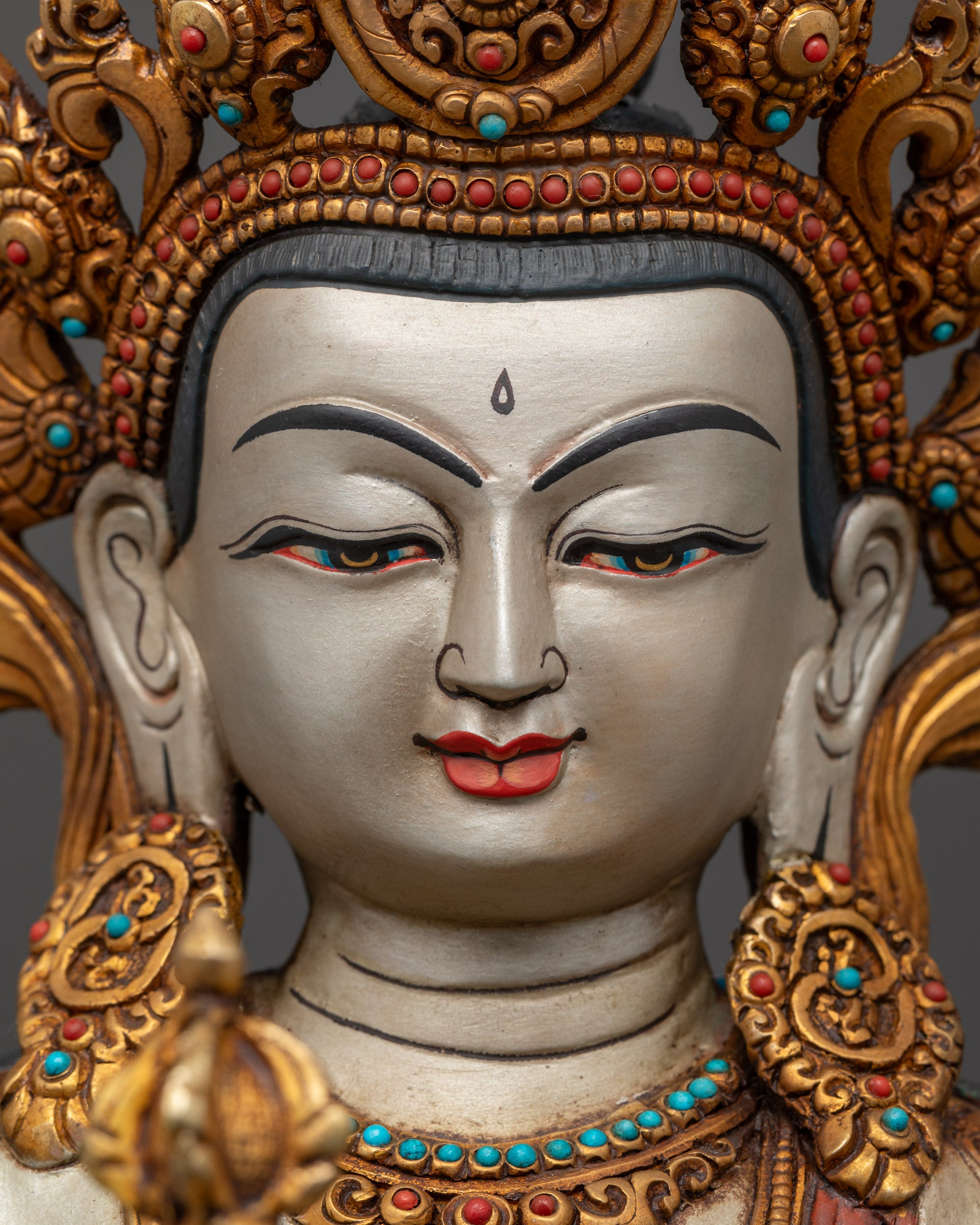 Detailed close up face of Vajrasattva and consort with gold-plated robe
