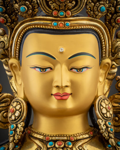 Detailed close up face of Vajrasattva statue with gold fire gilded serene expression
