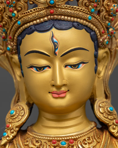 Detailed close up face of White Umbrella Dukar Statue with third eye and gold gilding
