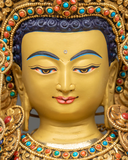 Detailed close up face of serene gold-gilded Jowo Shakyamuni Buddha with calm expression
