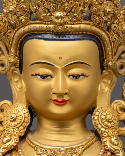 Detailed close up of Dorje Sempa statue showing serene gold-gilded face