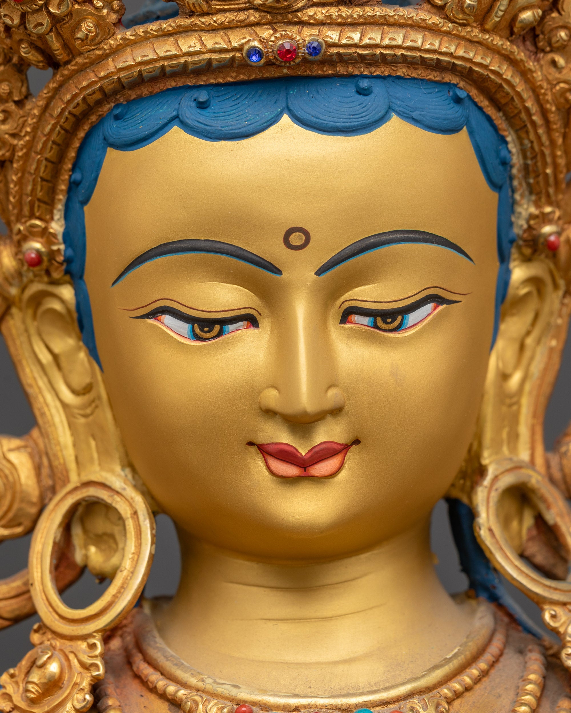 Detailed close up of Green Tara face showing serene expression and crown
