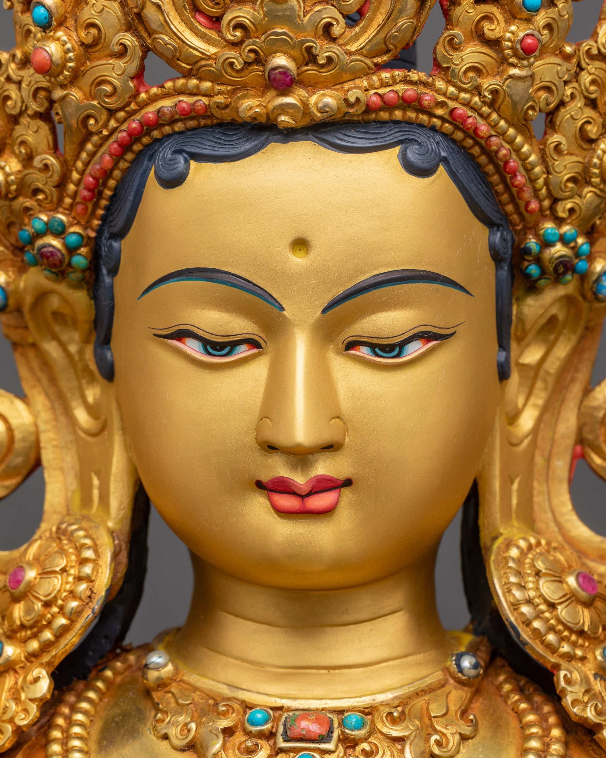 Detailed close up of Green Tara face with Five-Jeweled Crown and semi-precious jewelry stones