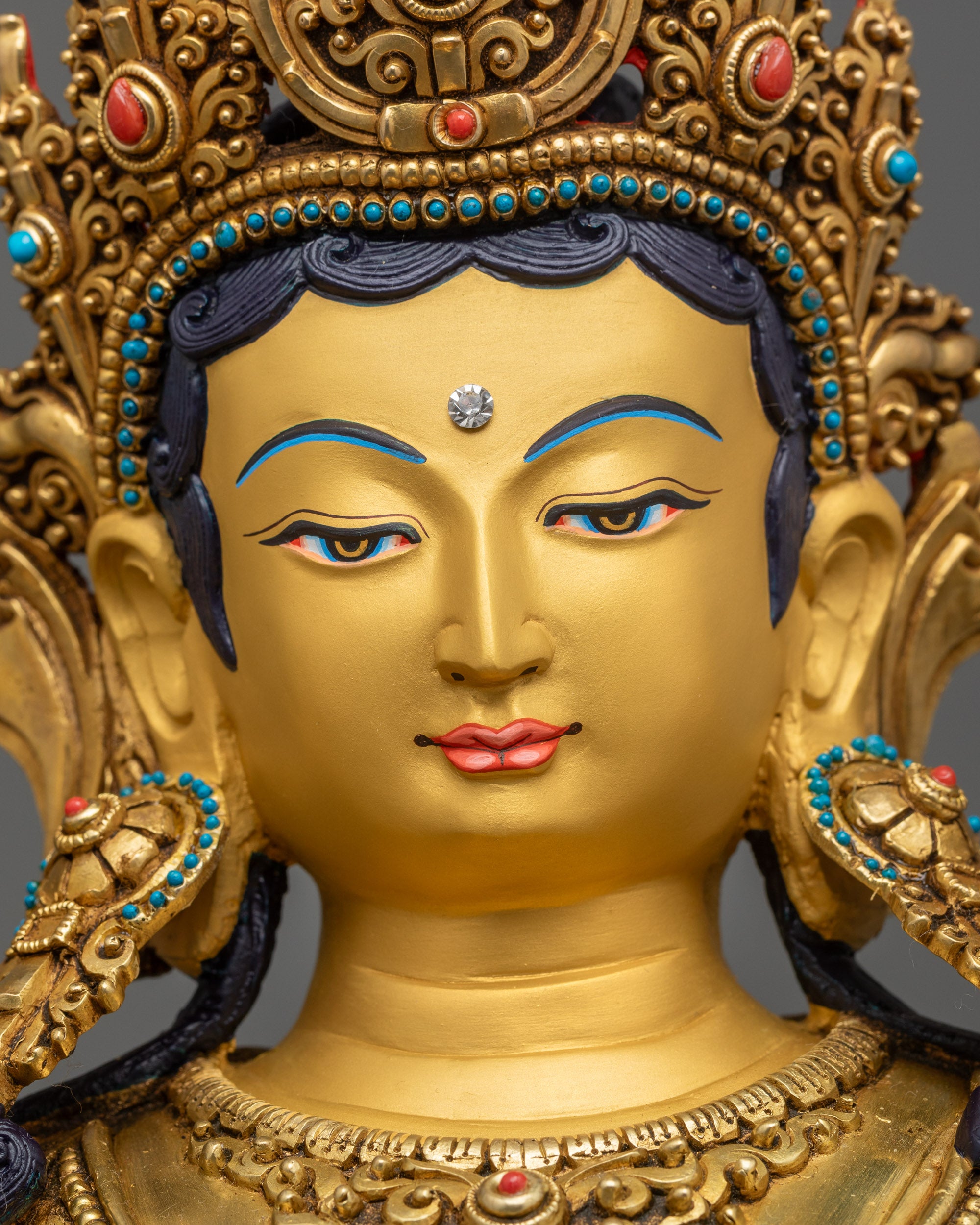 Detailed close up of Green Tara face showing serene expression and crown
