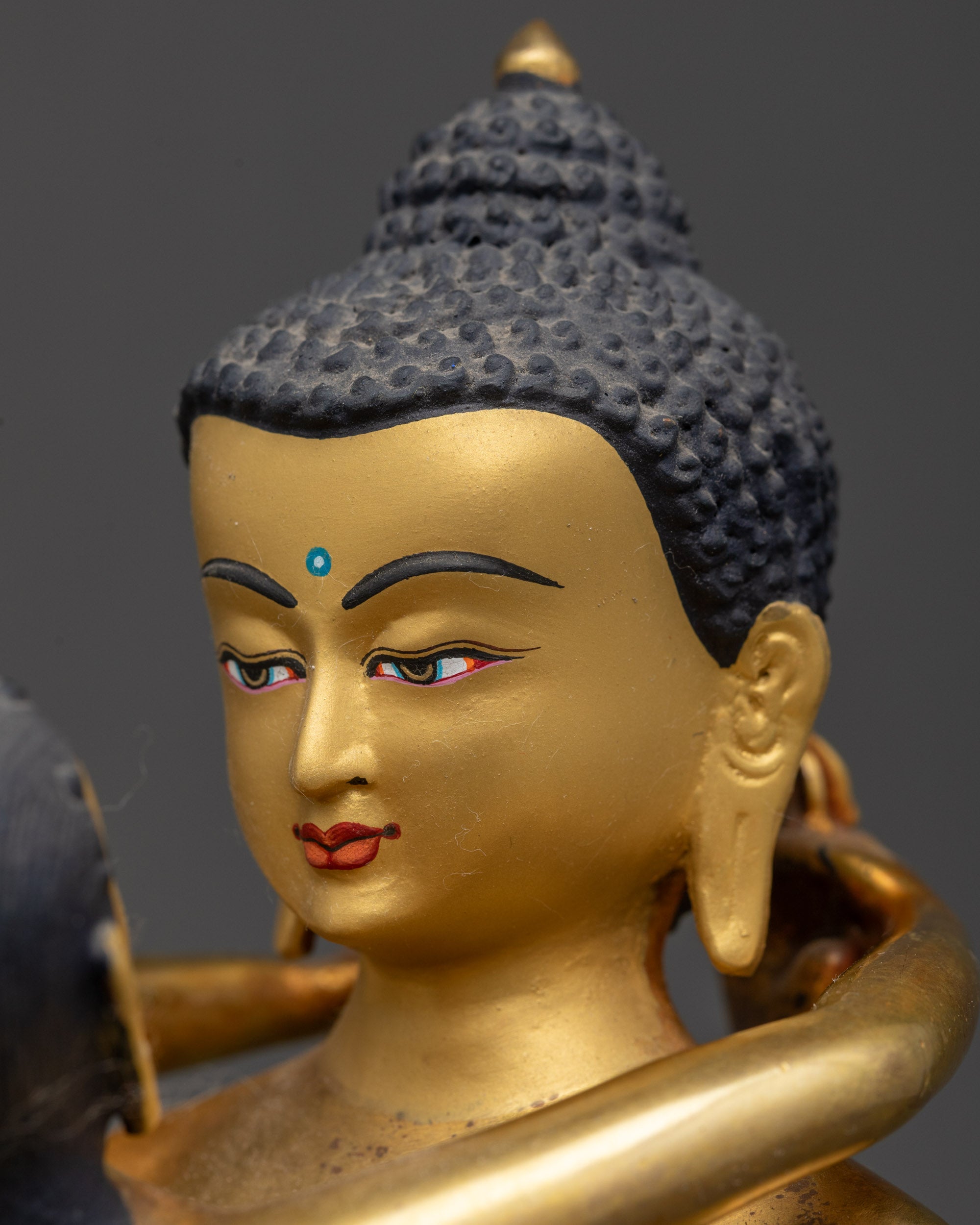 Detailed close up of Samantabhadra face Tibetan deity meditation statue on lotus base
