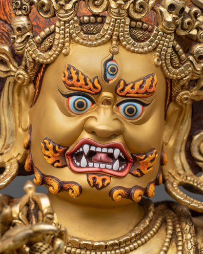 Detailed close up of Six-Armed Mahakala face with wrathful expression and gold gilding