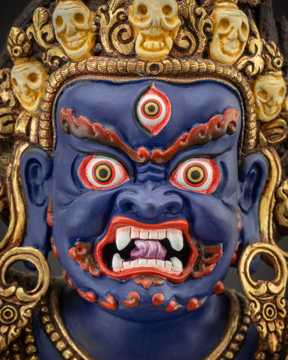 Detailed close up of Vajrapani face with skull crown, red brows, and bared fangs
